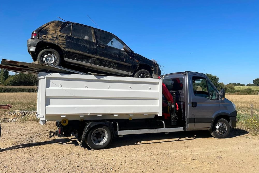 Une voiture hors d'usage chargée sur le camion-grue de Darel Services